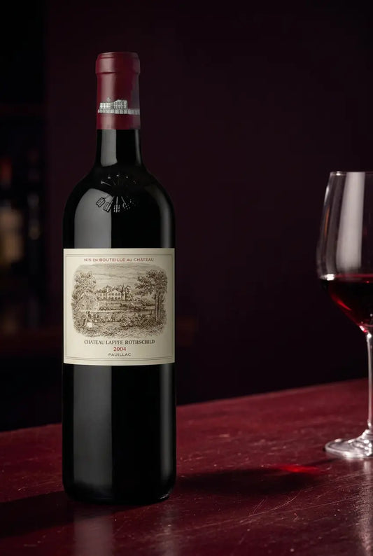 ChΓ’teau Lafite Rothschild 2004 wine bottle against a dark burgundy background