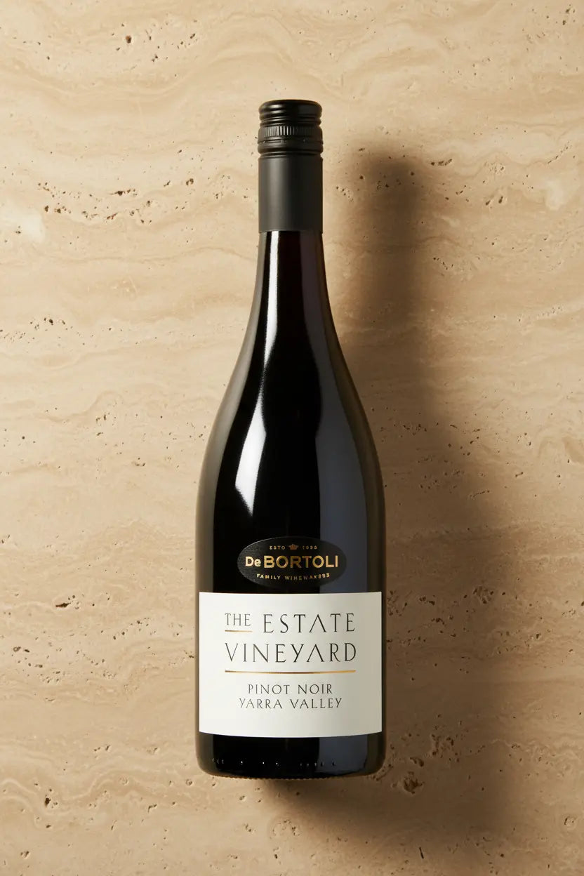 De Bortoli The Estate Vineyard Pinot Noir 2025 bottle on warm travertine stone surface, Yarra Valley